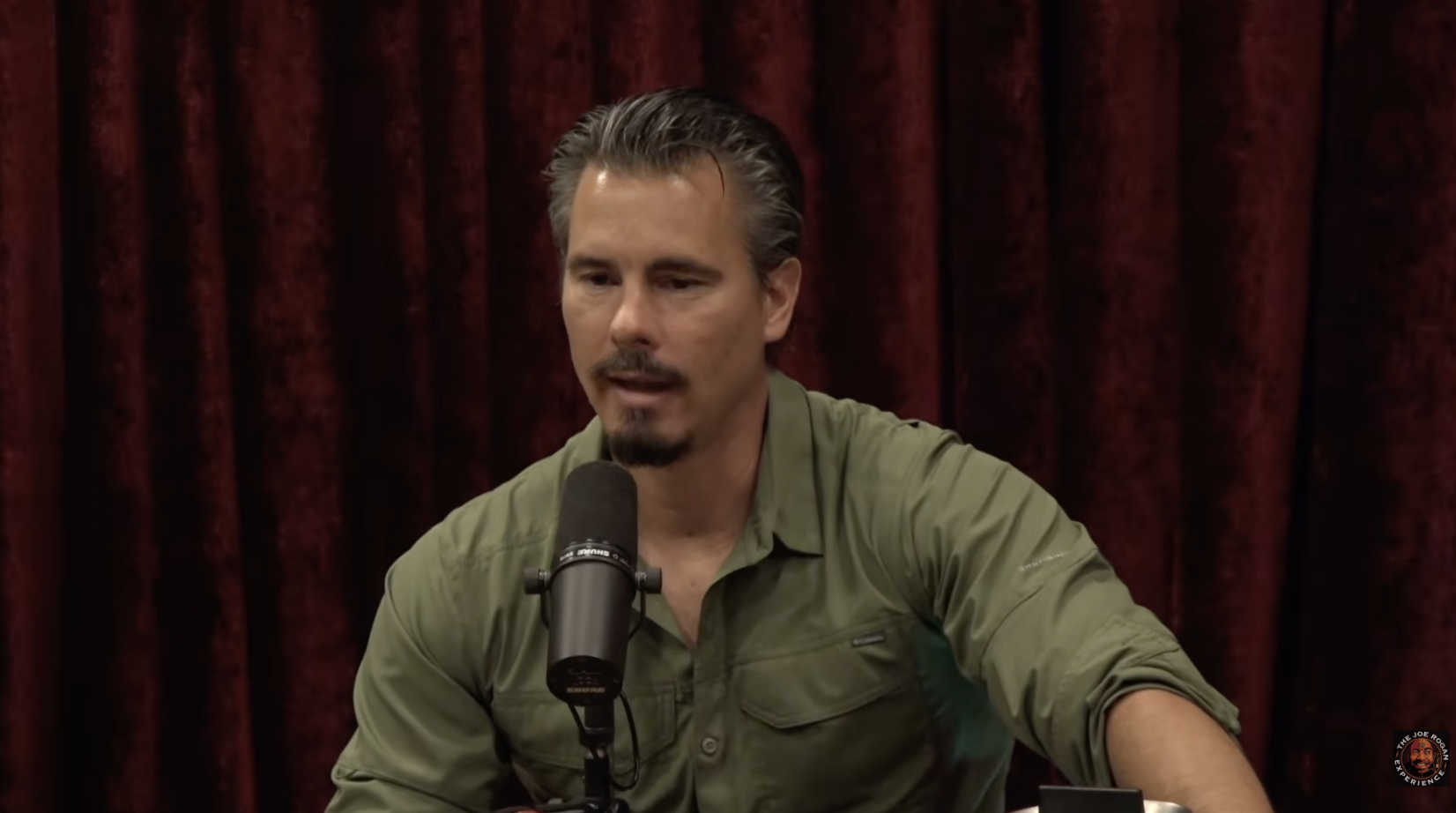 Timothy Alberino speaking into a microphone during The Joe Rogan Experience episode 2530